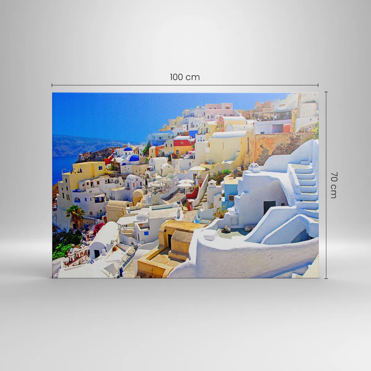 Obraz na płótnie - Panorama Santorini z białymi domami i błękitnym niebem - 100x70cm - Marzenie o greckim lecie - Nowoczesna dekoracja ścienna do salonu, kuchni i sypialni ARTTOR