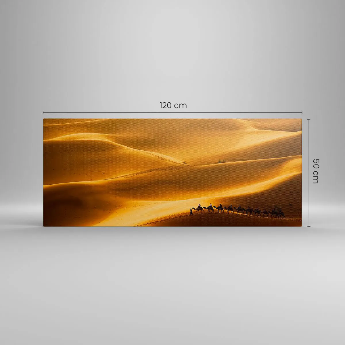 Bild auf Leinwand - Leinwandbild - Eine Karawane von Kamelen wandert durch die goldenen Dünen der Wüste. - 120x50cm - Wohnwagen in den Wüstenwellen - Moderne Wanddekoration für Wohnzimmer und Schlafzimmer ARTTOR