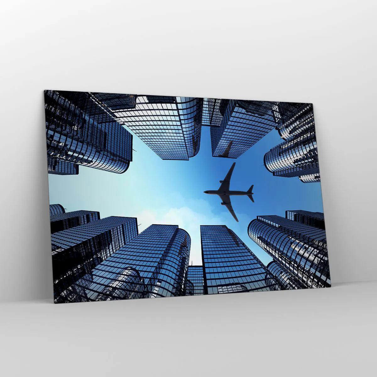Glasbild - Bild auf glas - Blick auf das Flugzeug zwischen Wolkenkratzern - 120x80cm - Der Blick aus der Glasschlucht - Moderne Wanddekoration für Wohnzimmer und Schlafzimmer ARTTOR
