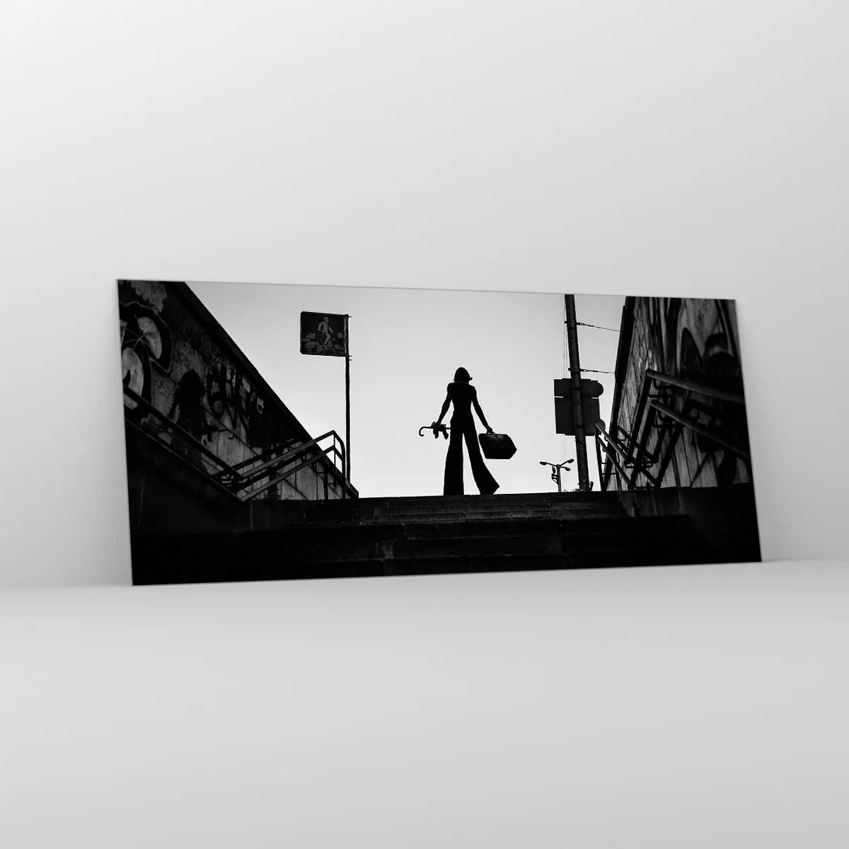 Impression sur verre - Image sur verre - Une figure de femme dans les escaliers en noir et blanc avec une atmosphère dynamique - 120x50cm - Pèlerinage urbain - Décoration murale moderne pour le salon et la chambre ARTTOR