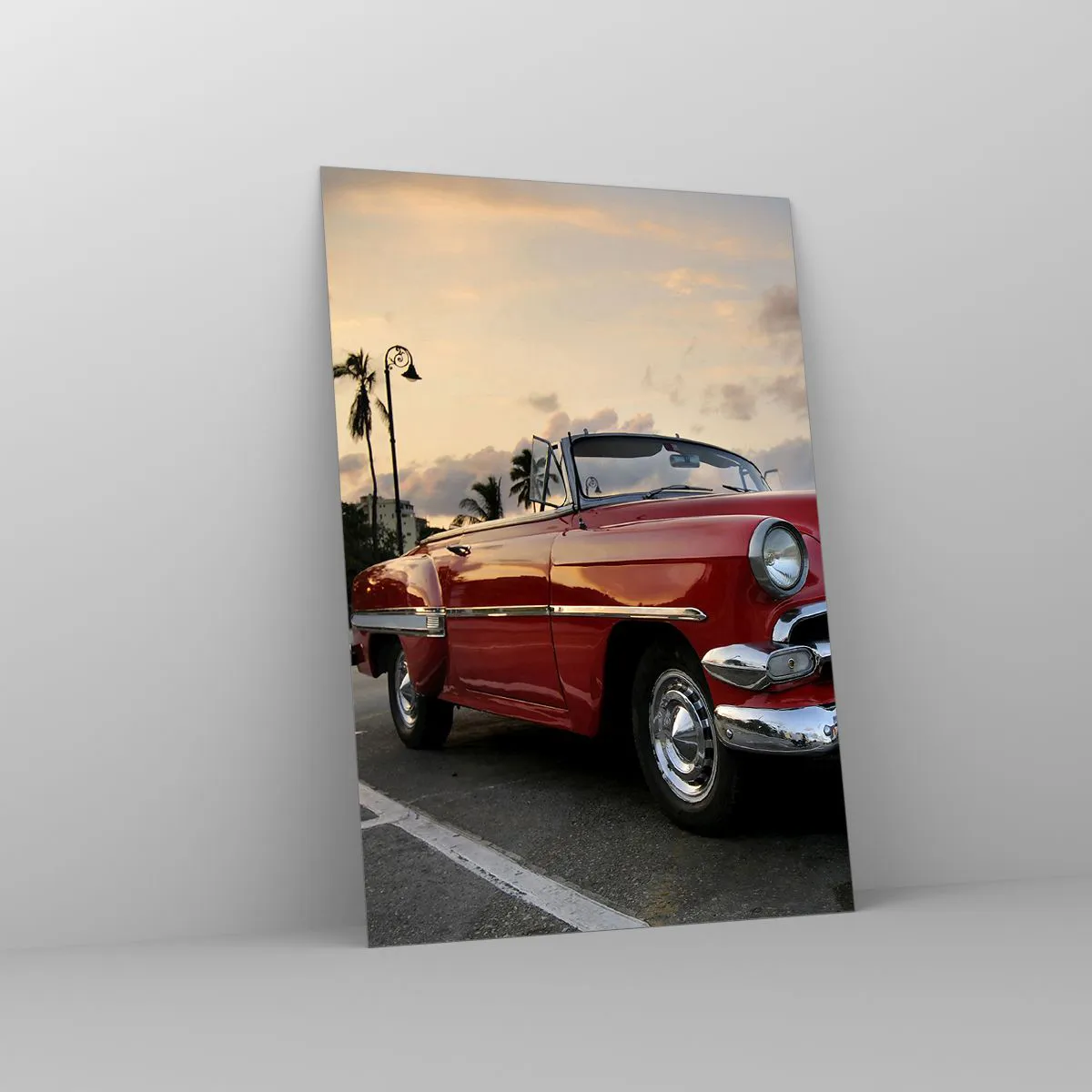 Obraz na szkle - Czerwony klasyczny kabriolet zaparkowany przy palmach o zmierzchu - 70x100cm - Czerwony żar tropików - Nowoczesna dekoracja ścienna do salonu i sypialni ARTTOR