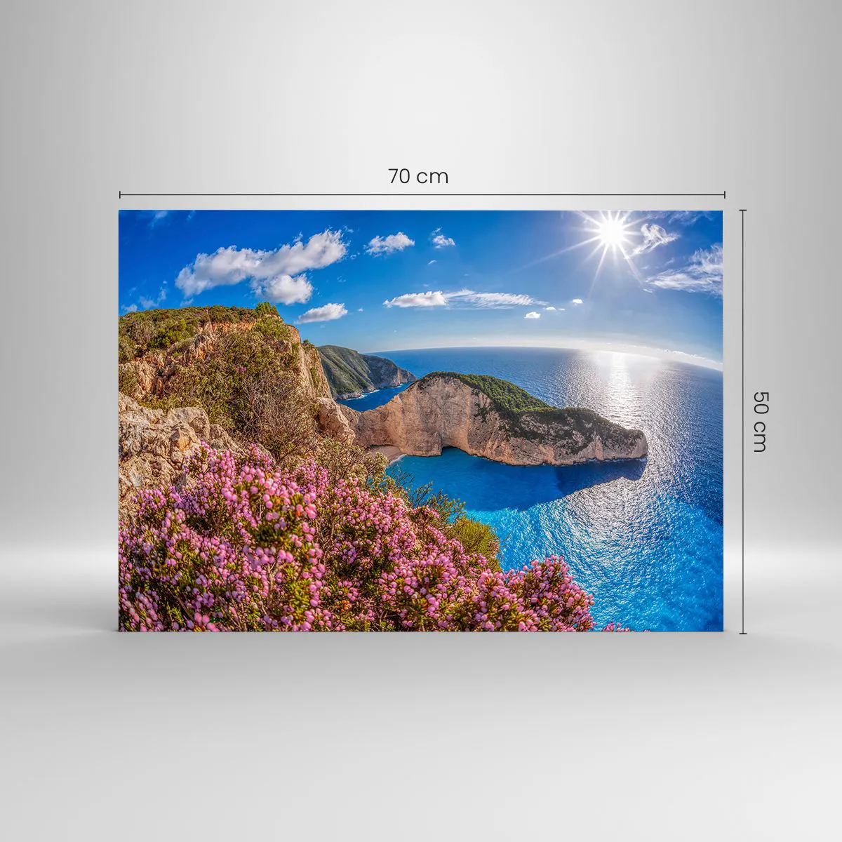 Tablou pe sticlă - Peisaj grecesc cu stânci, mare și arbuști înfloriți - 70x50cm - Marea mea vacanță grecească - Decorațiune modernă pentru perete pentru living și dormitor ARTTOR